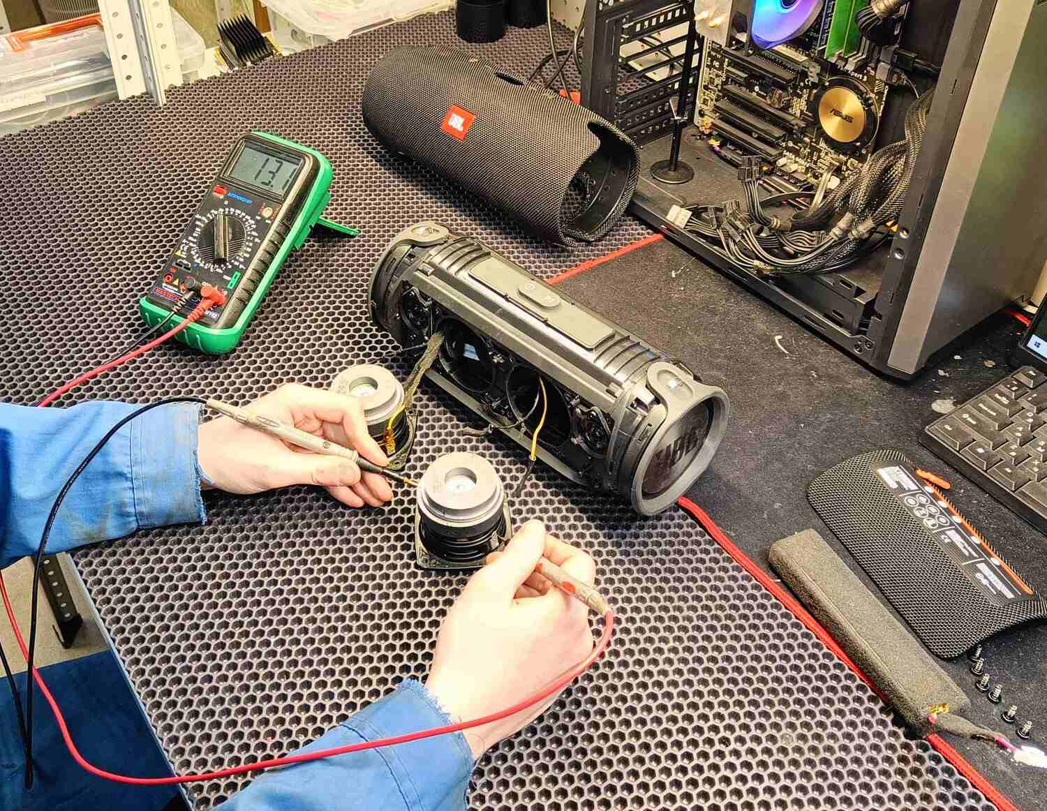 Portable Bluetooth speaker disassembled on the bench for driver and electronics testing