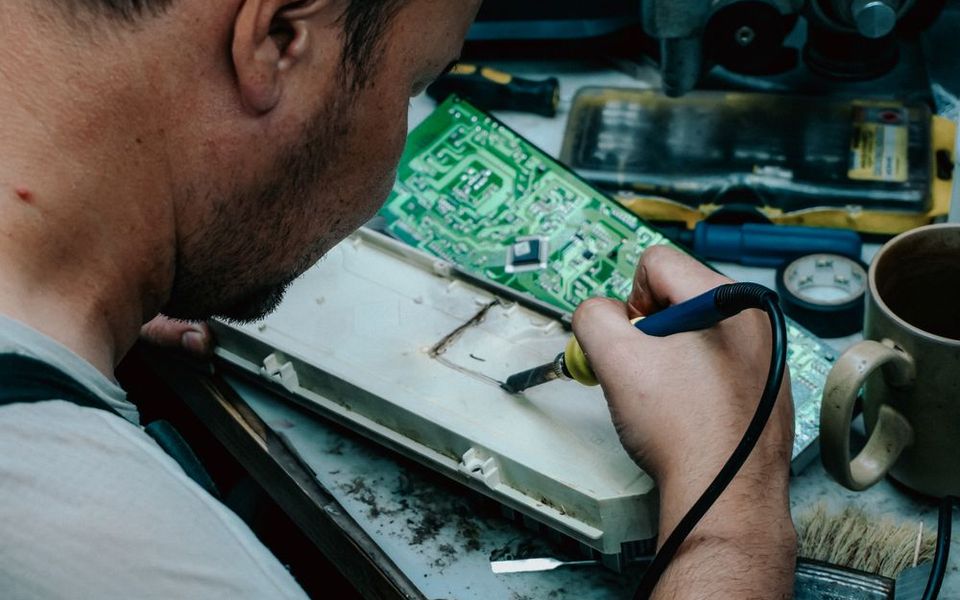 Technician soldering electronics