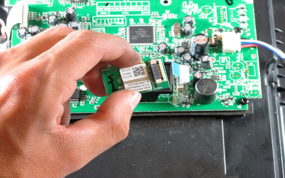 Sony Bluetooth module held in hand during repair