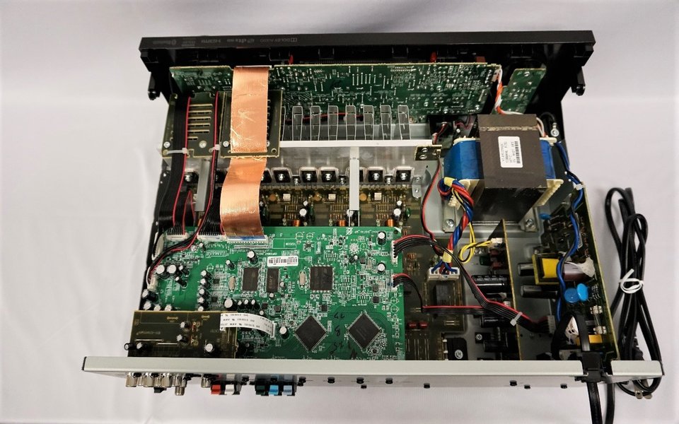 AV receiver opened up showing its power supply and internal boards