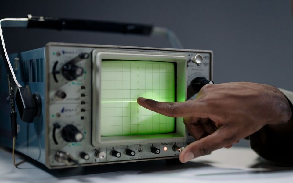 Technician reading an oscilloscope