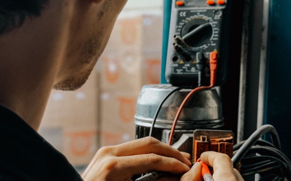 Technician measuring with a multimeter
