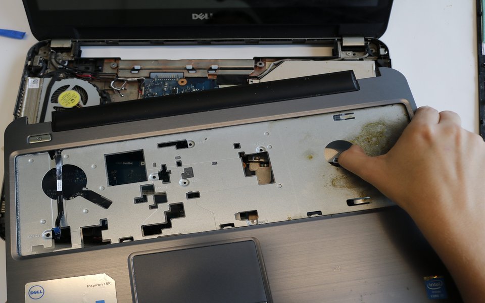 Dell laptop with the bottom cover removed on our workbench