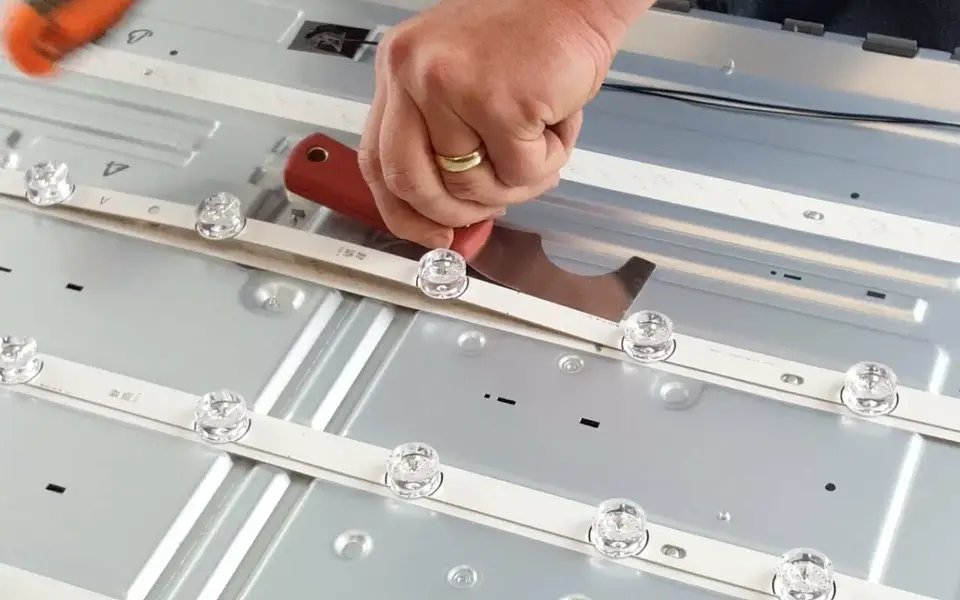 TV LED backlight strip being lifted out during replacement